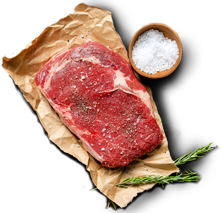 Seasoned Scotch Fillet Steak displayed on top of parchment paper.